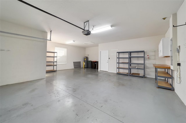 garage featuring a garage door opener and electric water heater