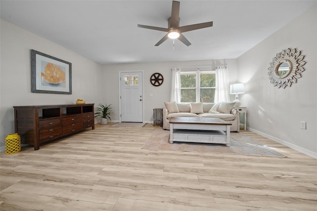 living room with light hardwood / wood-style floors and ceiling fan