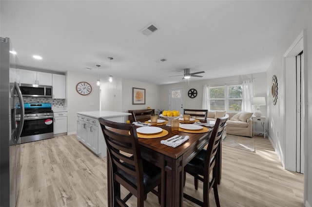 dining room featuring light hardwood / wood-style flooring and ceiling fan