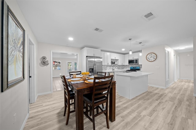 dining area with light hardwood / wood-style flooring