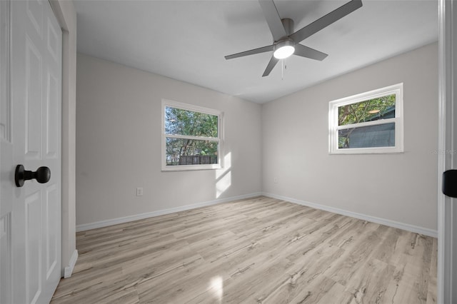 spare room with ceiling fan, plenty of natural light, and light hardwood / wood-style floors