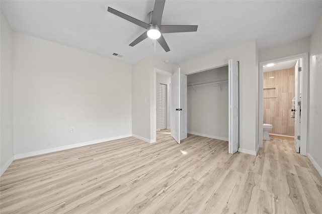 unfurnished bedroom with ensuite bath, light hardwood / wood-style flooring, a closet, and ceiling fan