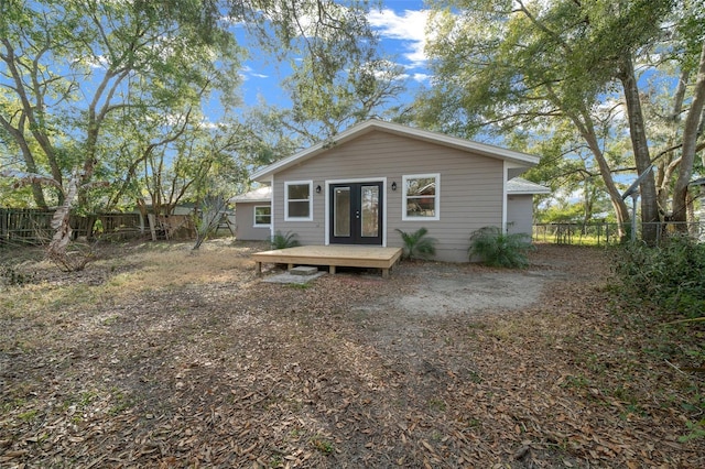 back of property featuring french doors and a deck