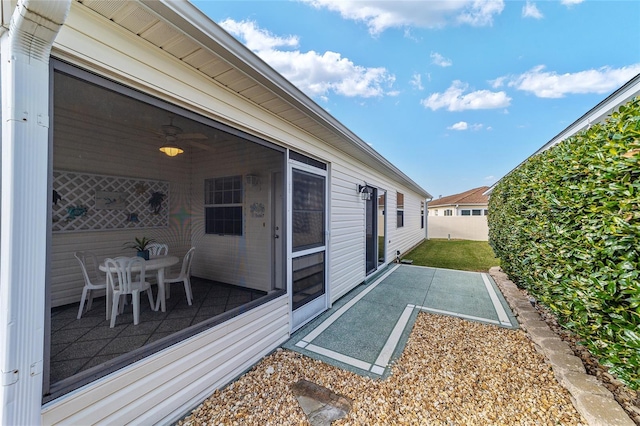 exterior space with ceiling fan