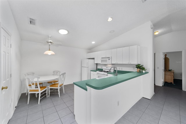 kitchen with white cabinetry, white appliances, lofted ceiling, and kitchen peninsula