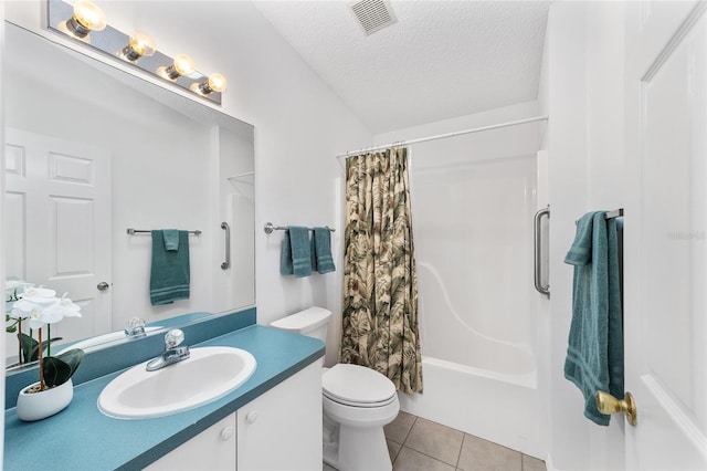 full bathroom featuring vanity, toilet, shower / bath combo, tile patterned floors, and a textured ceiling