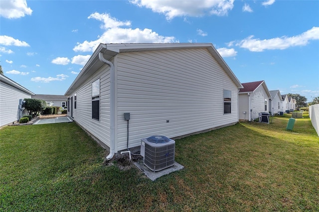 view of home's exterior featuring a lawn and central air condition unit