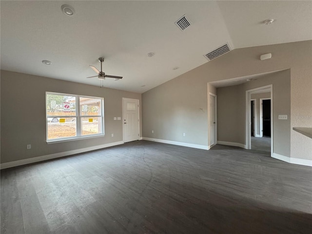 empty room with ceiling fan, dark hardwood / wood-style flooring, and vaulted ceiling