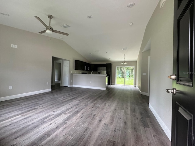 unfurnished living room with vaulted ceiling, dark wood-type flooring, and ceiling fan