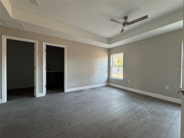 unfurnished bedroom with ceiling fan and dark hardwood / wood-style flooring