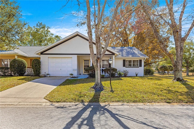 ranch-style house featuring a garage and a front lawn