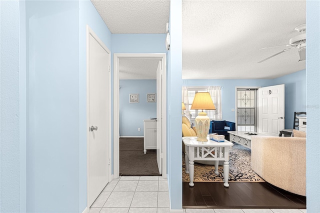 interior space with light tile patterned floors and a textured ceiling