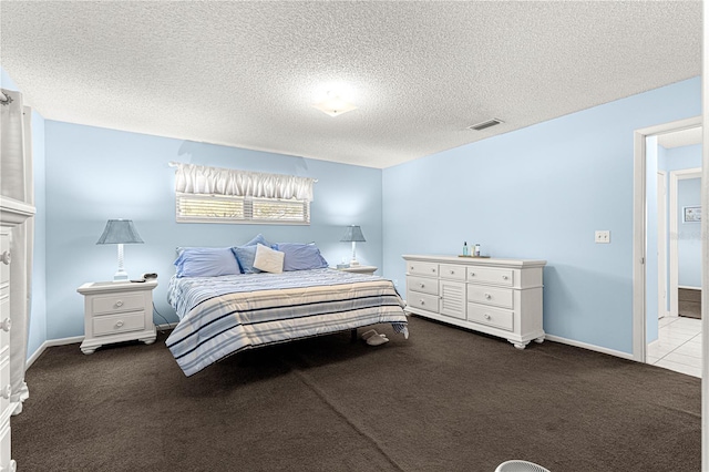 carpeted bedroom featuring a textured ceiling