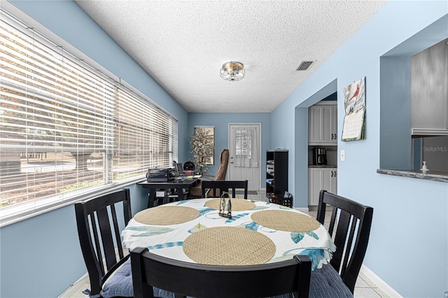 dining space with a textured ceiling