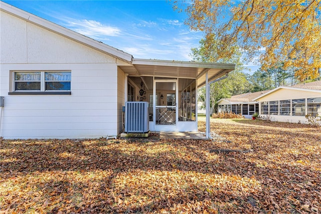 back of house featuring cooling unit and a sunroom