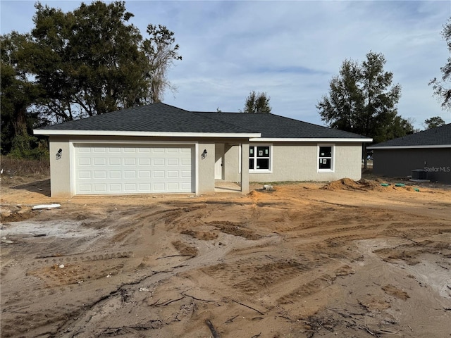 view of front of house featuring cooling unit and a garage