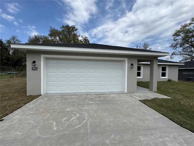 exterior space with stucco siding, an attached garage, concrete driveway, and a front yard