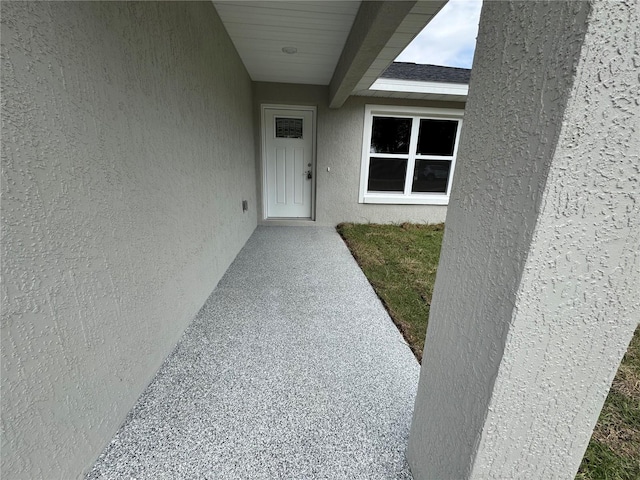 entrance to property with stucco siding