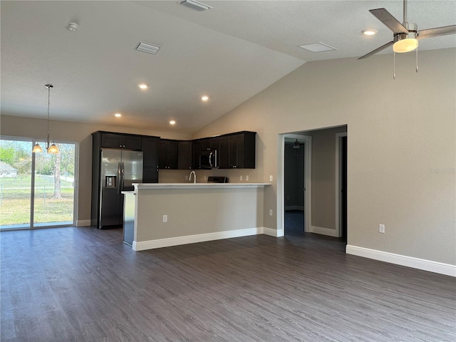 kitchen featuring visible vents, stainless steel appliances, light countertops, and open floor plan