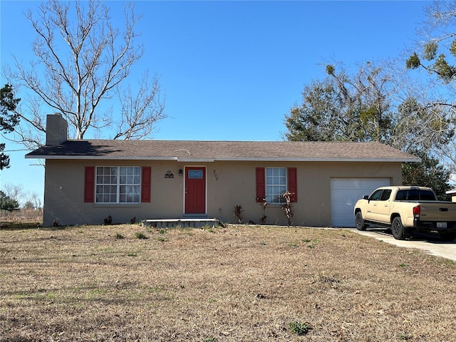 ranch-style home featuring a garage and a front yard