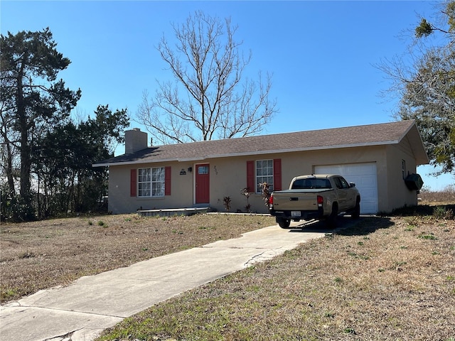 ranch-style home with a garage and a front yard