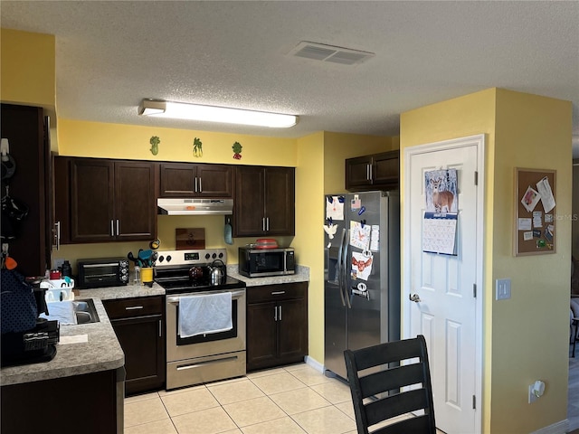 kitchen featuring light tile patterned flooring, dark brown cabinetry, stainless steel appliances, and sink