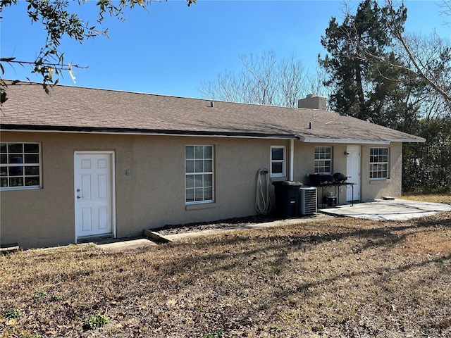 back of house with a patio, a yard, and central AC unit