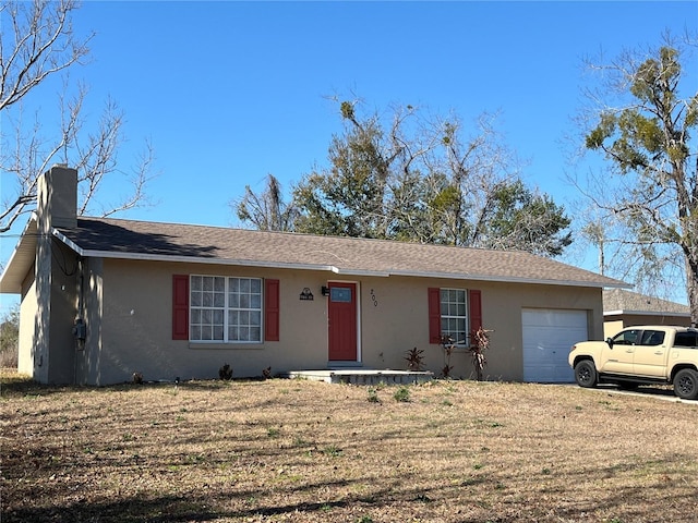 single story home with a garage and a front yard