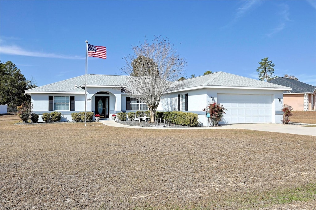 single story home featuring a garage and a front yard