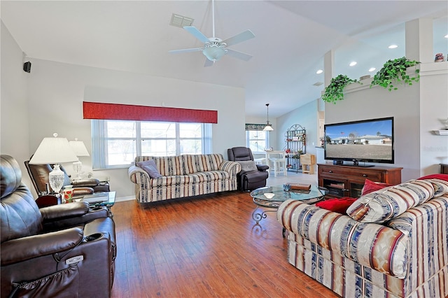 living room with ceiling fan, high vaulted ceiling, dark hardwood / wood-style floors, and a healthy amount of sunlight