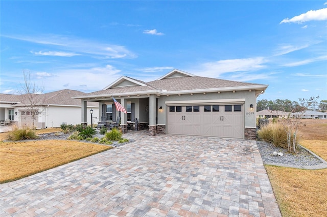 view of front of house with a porch, a garage, and a front yard