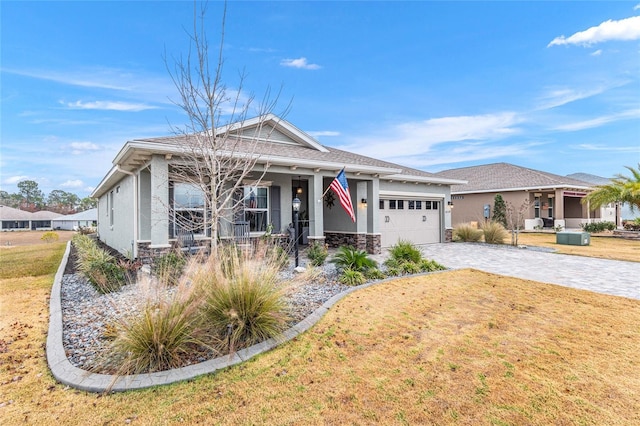 view of front of property with a garage, a front lawn, and a porch