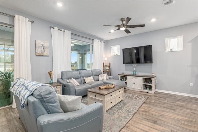 living room featuring ceiling fan and wood-type flooring