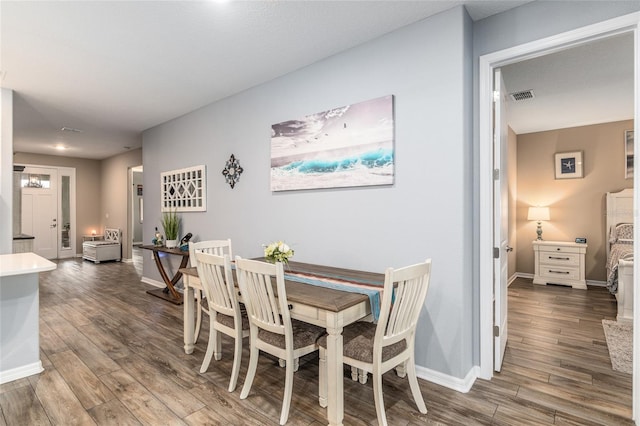 dining room with dark wood-type flooring