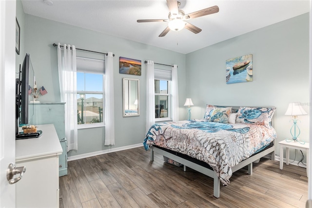 bedroom with ceiling fan and wood-type flooring