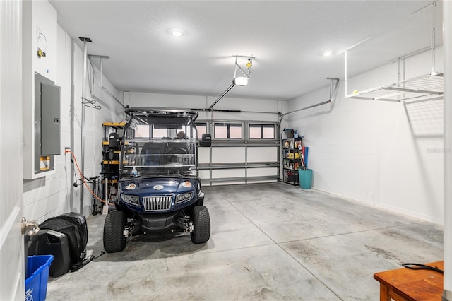 garage with a garage door opener and electric panel