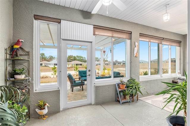 sunroom featuring ceiling fan