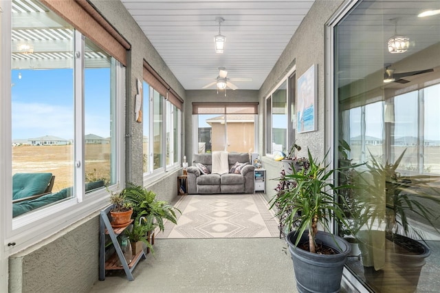 sunroom / solarium featuring ceiling fan