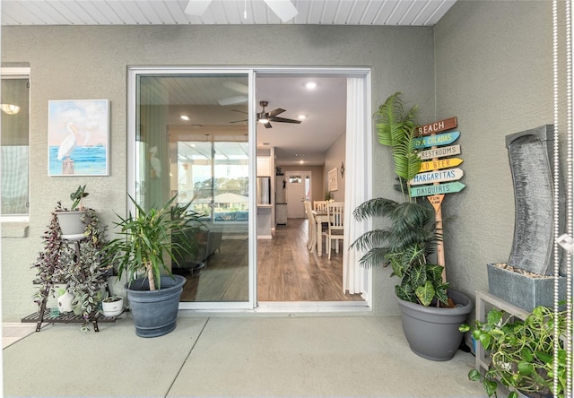 entrance to property featuring ceiling fan