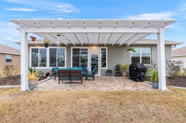 back of property featuring a patio, outdoor lounge area, a lawn, and a pergola