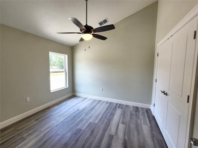 7799 SW 132nd Pl Unit 10, Ocala, FL 34473 - unfurnished bedroom with dark wood finished floors, a textured ceiling, a textured wall, and ceiling fan