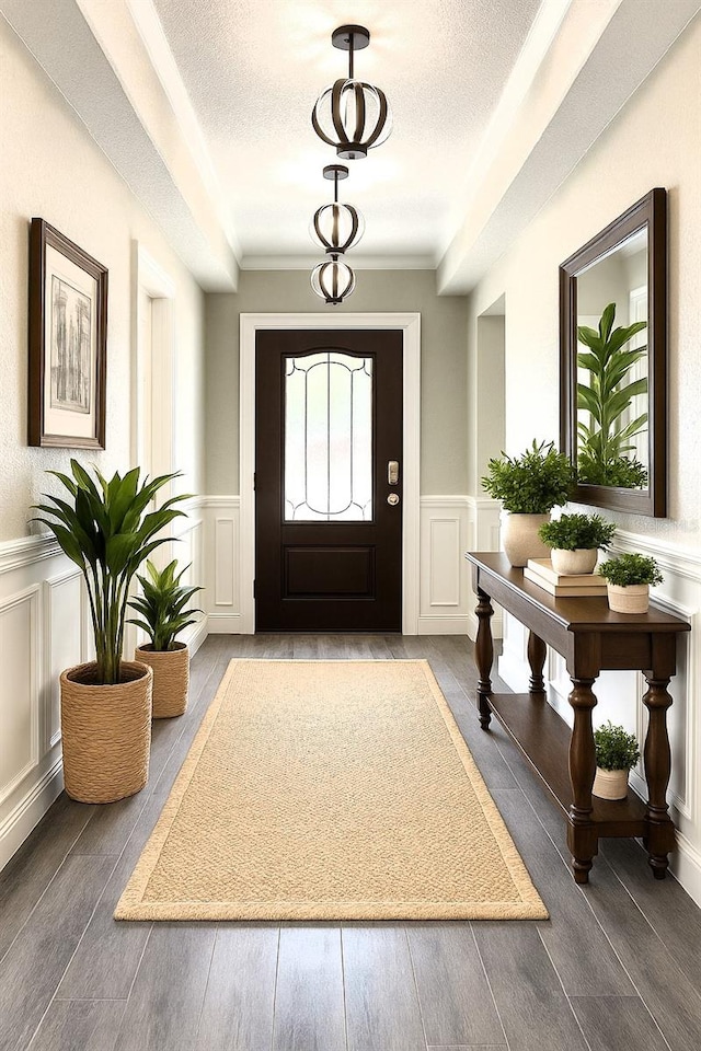 7799 SW 132nd Pl Unit 10, Ocala, FL 34473 - entryway featuring a decorative wall, a wainscoted wall, a textured ceiling, and wood finished floors