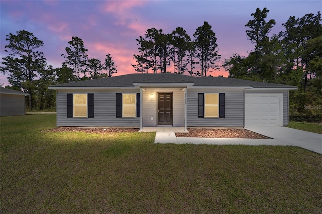 ranch-style house with a garage and a lawn