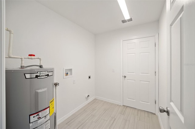 washroom featuring washer hookup, hookup for an electric dryer, light hardwood / wood-style floors, and water heater