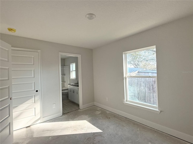 unfurnished bedroom featuring ensuite bath