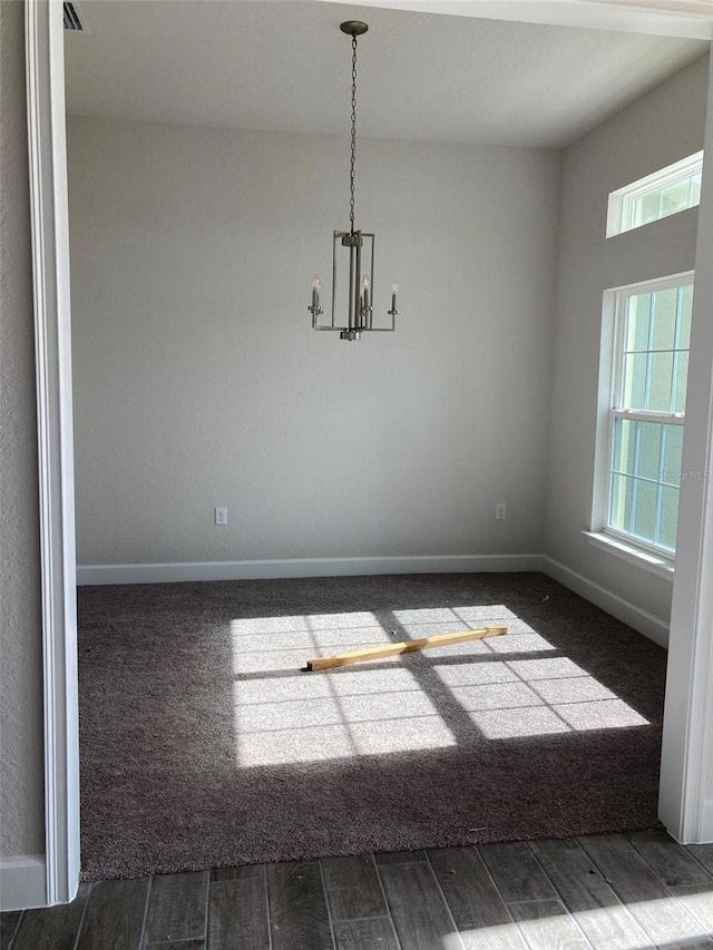 unfurnished dining area featuring an inviting chandelier