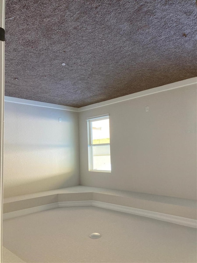 empty room featuring a textured ceiling