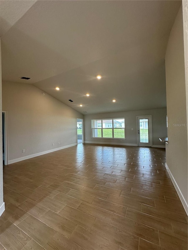 empty room featuring vaulted ceiling