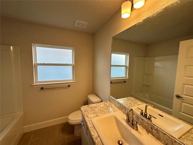 full bathroom with vanity, wood-type flooring, toilet, and plenty of natural light