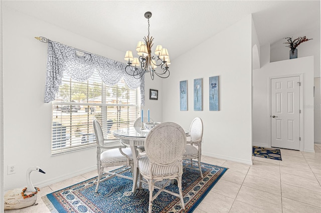 tiled dining area featuring lofted ceiling and a chandelier